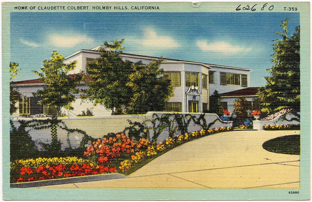 Postcard: a white modern house behind a curving drive and flower beds, titled Home of Claudette Colbert, Holmby Hills, California