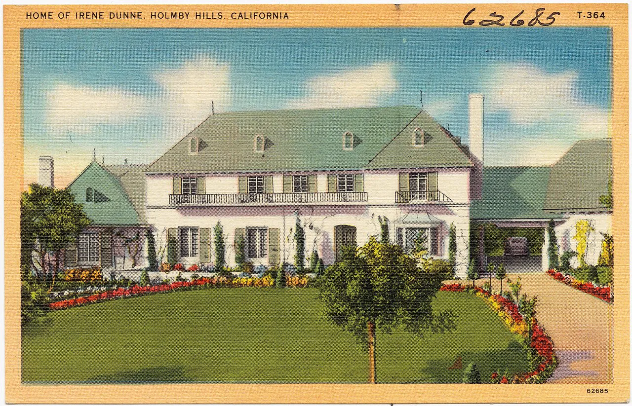 Postcard: a gabled two-storey house with a broad lawn, titled Home of Irene Dunne, Holmby Hills, California